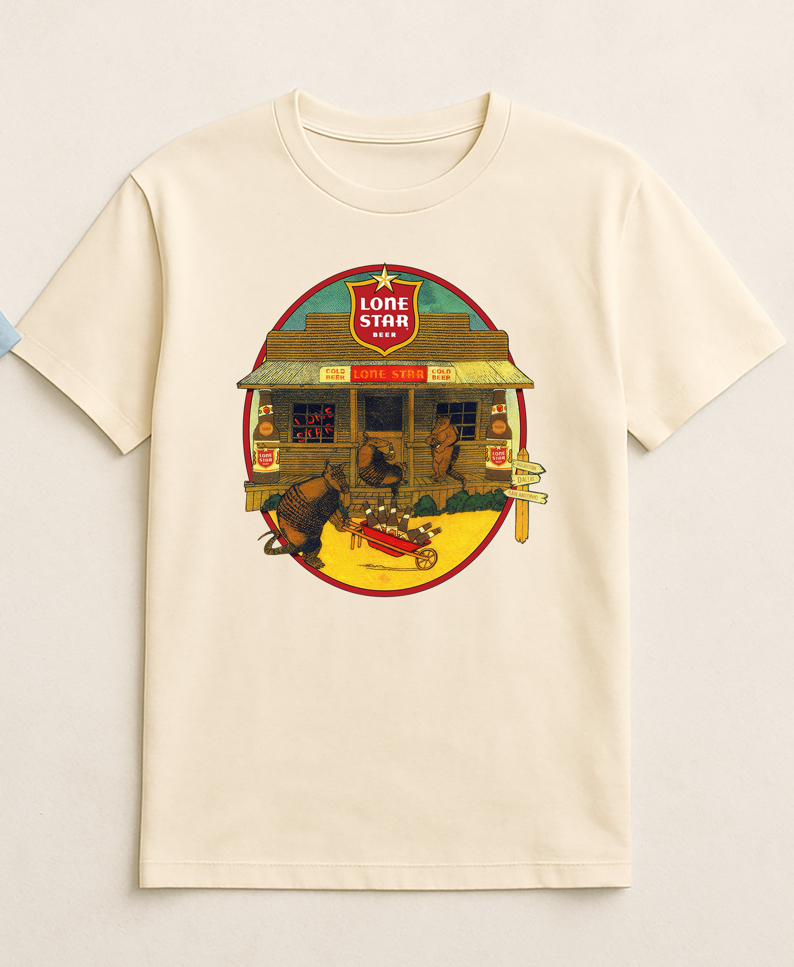 Vintage-style Lone Star Beer graphic T-shirt featuring armadillos outside a rustic Texas country store drinking Lone Star Beer, printed locally in Austin, Texas.